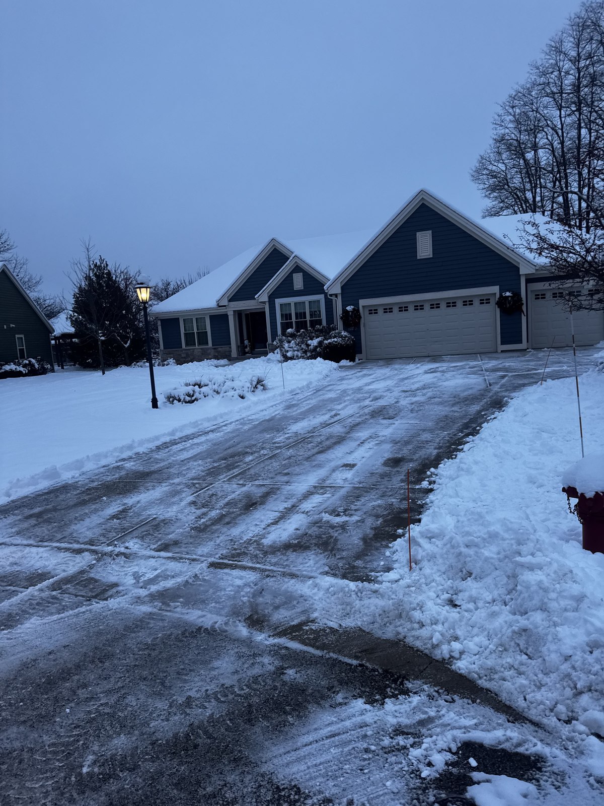 A cleanly plowed Lake Country driveway on a crisp winter morning by the lake
